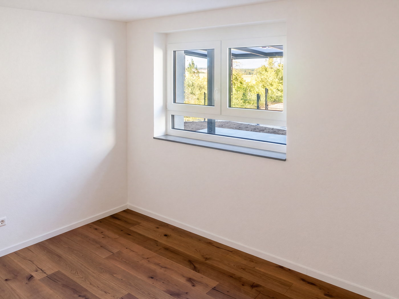 Schlafzimmer mit Eichenparkett und Fenster