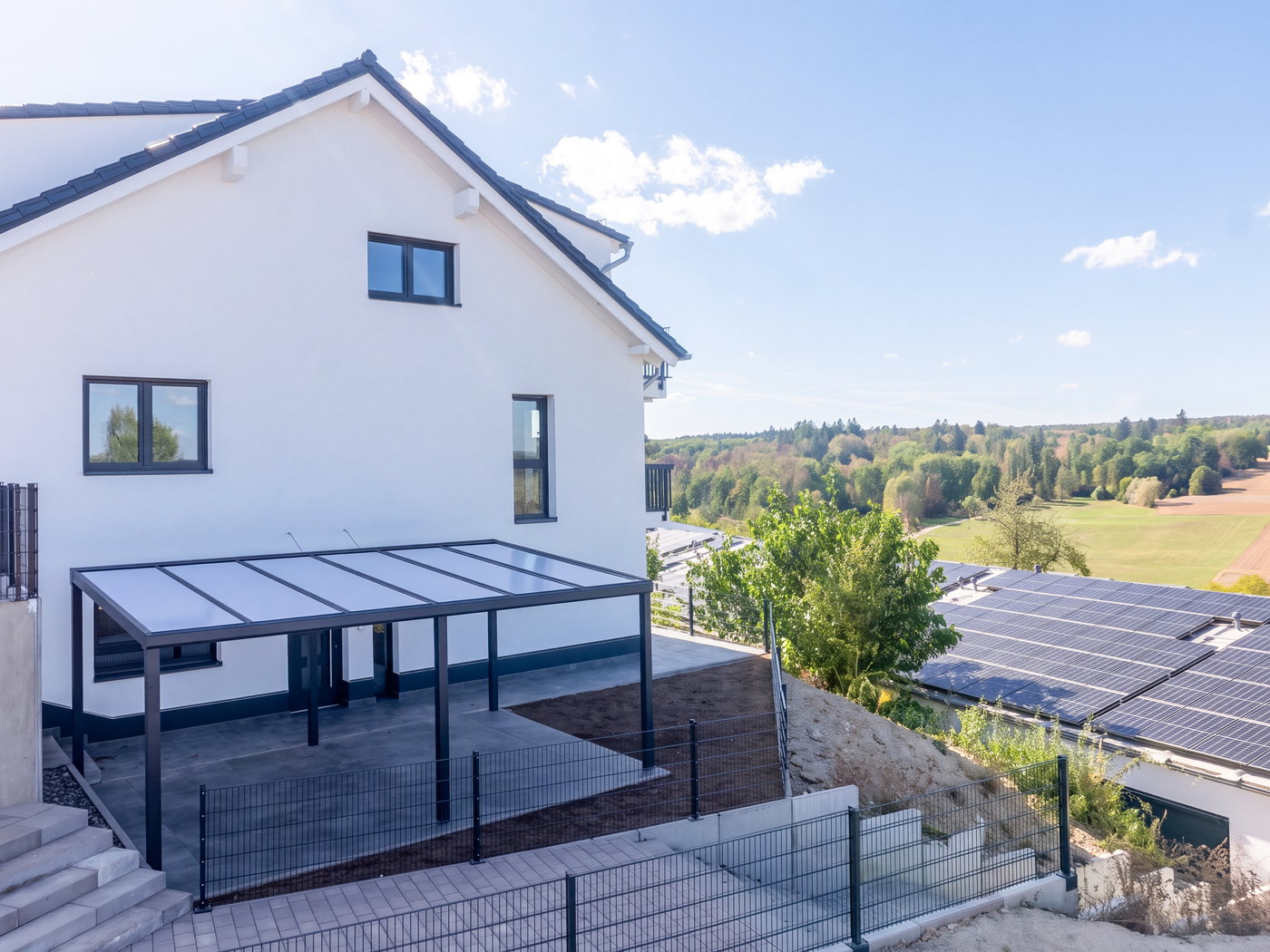 Überdachte Terrasse am Gebäude mit Blick über die Felder